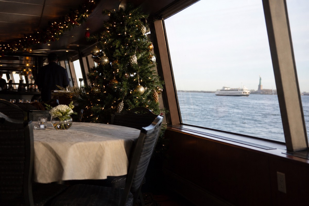Holiday-decorated yacht saloon on a December New York harbor cruise