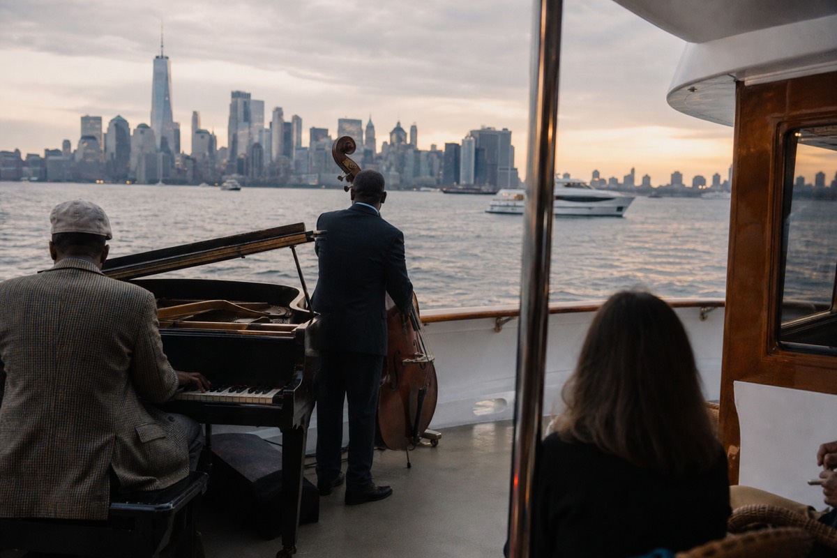 Live jazz trio playing aboard a classic motor yacht on New York Harbor at sunset